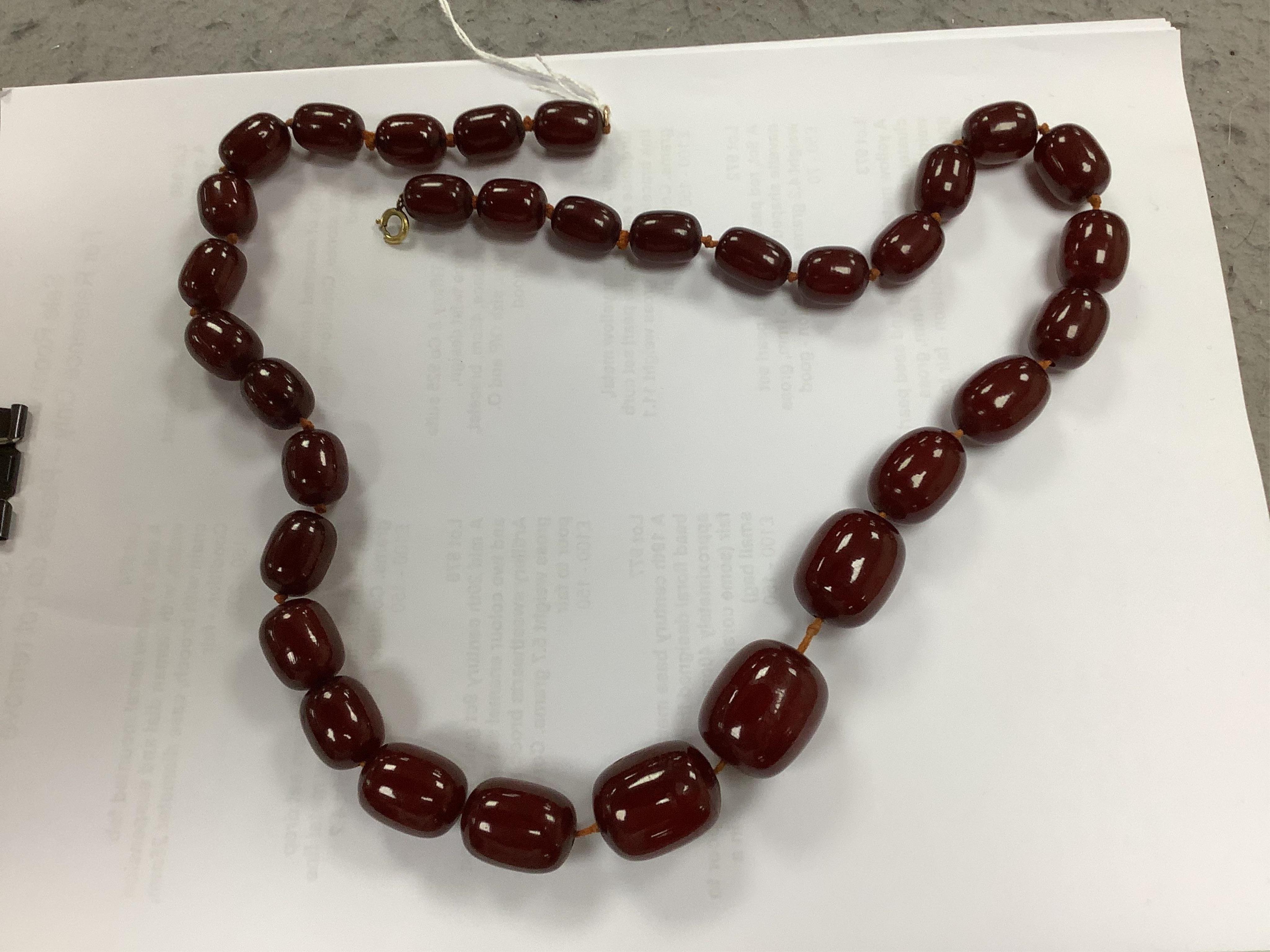 A single strand graduated simulated cherry amber necklace, 68cm gross weight 108 grams, Condition - fair